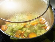 Bean soup in saucepan — Stock Photo