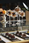 Desserts under glass cloches — Stock Photo