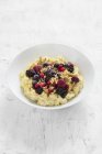 Creamy millet porridge with berries and nuts — Stock Photo