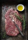 Raw beef steak on baking tray — Stock Photo