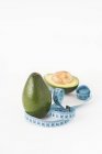 Fresh avocados with measuring tape — Stock Photo