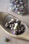 Shelled pistachios on wood spoon — Stock Photo