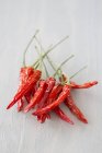 Dried red chilis  on white surface — Stock Photo