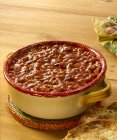 Oklahoma baked beans in pot  over wooden surface — Stock Photo