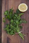 Fresh bunch of parsley and lemon half — Stock Photo