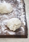 Pizza dough with flour — Stock Photo