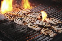 Chicken fillets on grill — Stock Photo