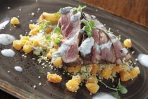 Lamb with couscous on plate — Stock Photo