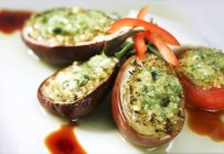 Stuffed aubergines and stuffed tomatoes on white surface — Stock Photo