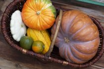 Various pumpkins in basket — Stock Photo