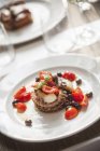 Polpo con pomodorini e olive - octopus was cherry tomatoes and olives on white plate — Stock Photo