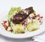 Hanger steak on lettuce hearts — Stock Photo