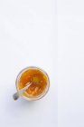Apricot jam in glass with spoon — Stock Photo