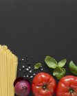 Uncooked spaghetti pasta and spices — Stock Photo
