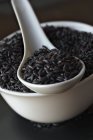 Black rice in bowl — Stock Photo