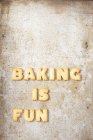 Top view of words Baking is fun made of biscuit letters — Stock Photo