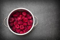 Pot of frozen raspberries — Stock Photo
