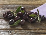 Kalamata olives with leaves — Stock Photo