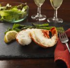 Closeup view of Lobster tails with lemon, asparagus and salad — Stock Photo