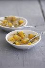 Marinated scallops with oranges on plates over wooden surface — Stock Photo