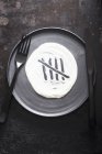 Grey plate with cutlery — Stock Photo