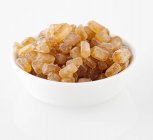Closeup view of rock sugar in white bowl — Stock Photo