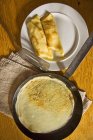 Top view of crepes in a pan and on a plate — Stock Photo