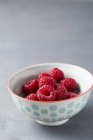 Fresh Raspberries in bowl — Stock Photo