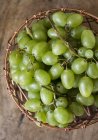 Green grapes in wire basket — Stock Photo