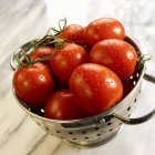 Red tomatoes in colander — Stock Photo