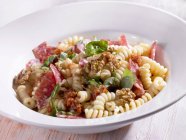 Spiral pasta with salami — Stock Photo
