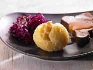 Close up of Roast pork with a dumpling and red cabbage — Stock Photo