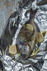 Sea bream roasted in aluminium foil — Stock Photo