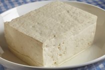 Closeup view of Tofu cheese piece in white bowl — Stock Photo