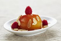 Honey peaches with almonds — Stock Photo