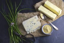 Arrangement of butter over blue surface — Stock Photo