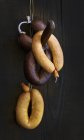 Sausages hanging on hook — Stock Photo