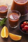 Tomato and orange juice — Stock Photo
