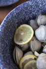 Steamed clams in a white wine broth with garlic and herbs in an enamel pot — Stock Photo