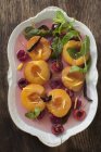 Poached peaches with cherries — Stock Photo