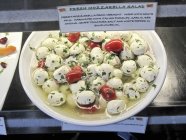 Mozzarella salad in delicatessen stall — Stock Photo