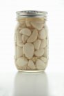 Jar of pickled garlic cloves — Stock Photo