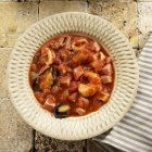 Top view of seafood stew with Serrano ham — Stock Photo
