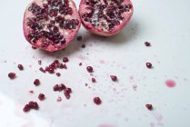Halved pomegranate with seeds — Stock Photo