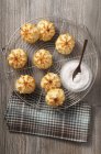 Closeup view of coconut Rochers with icing sugar on wire cooling rack — Stock Photo
