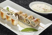 Stuffed pork roll skewers with pear mousse — Stock Photo