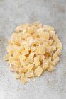 Closeup view of candied ginger pieces heap on white surface — Stock Photo