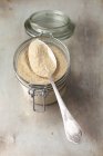 Breadcrumbs in jar with spoon — Stock Photo