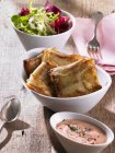 Stuffed potato parcels with dip and salad — Stock Photo