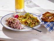 Fried potatoes with sausage salad and beer — Stock Photo